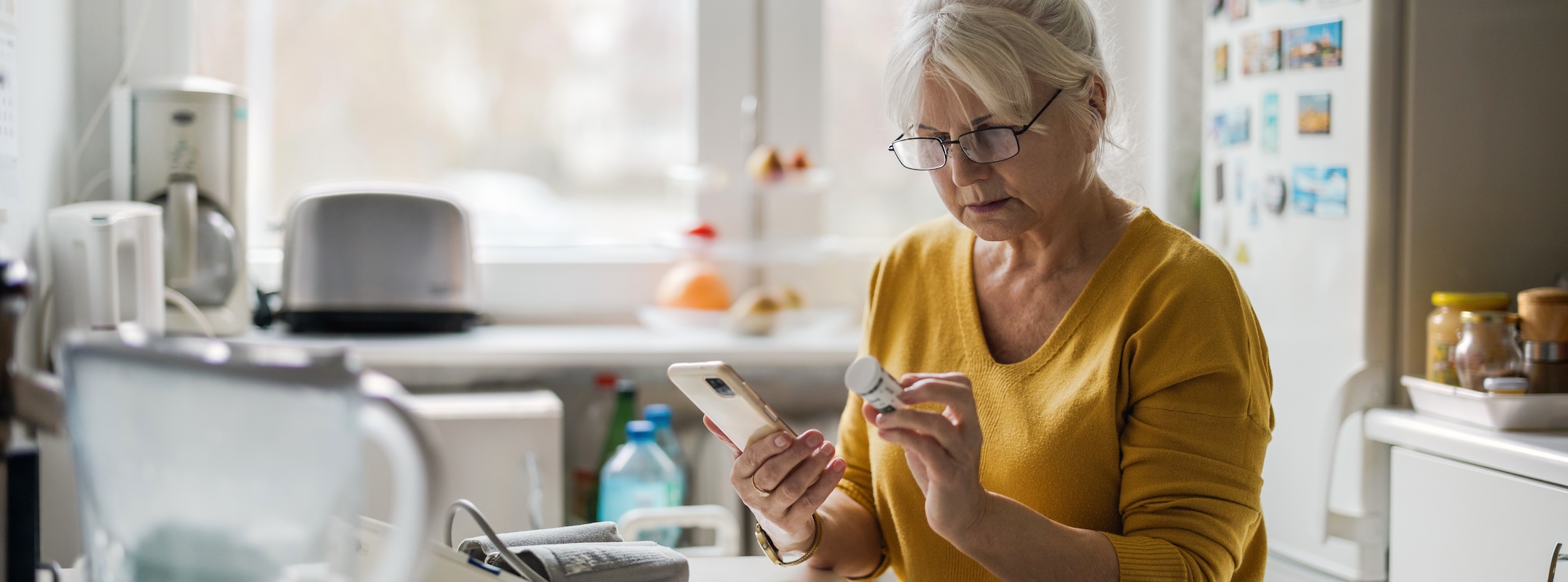 woman viewing pill bottle in a lit room